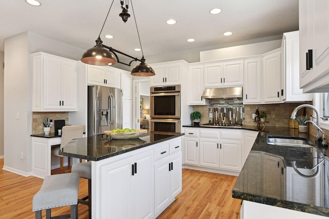7604 Delaney Blvd, Edina, MN 55439 - kitchen with light wood finished floors, a sink, appliances with stainless steel finishes, and white cabinetry