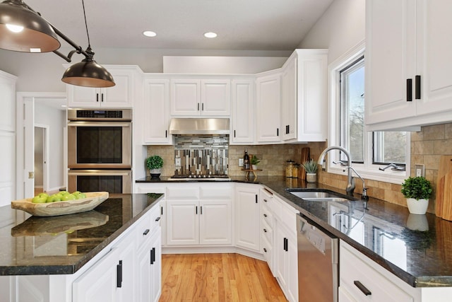 7604 Delaney Blvd, Edina, MN 55439 - kitchen featuring under cabinet range hood, appliances with stainless steel finishes, white cabinets, a sink, and light wood-type flooring
