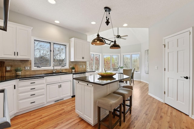 7604 Delaney Blvd, Edina, MN 55439 - kitchen featuring tasteful backsplash, dishwasher, a sink, visible vents, and a textured ceiling