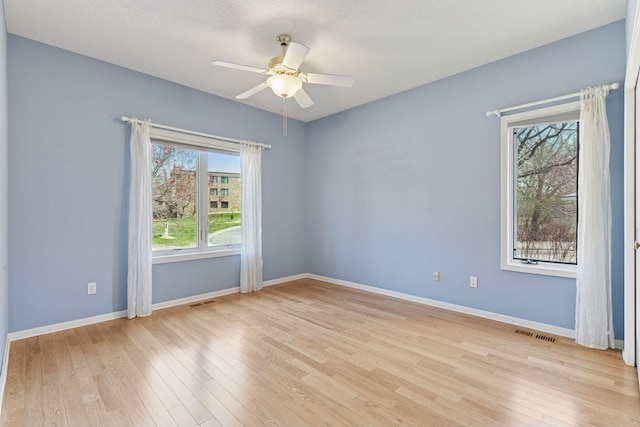 7604 Delaney Blvd, Edina, MN 55439 - empty room with visible vents, ceiling fan, baseboards, and light wood-style floors