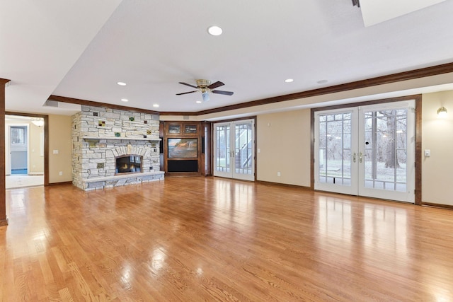 7604 Delaney Blvd, Edina, MN 55439 - unfurnished living room with crown molding, light wood-style floors, baseboards, french doors, and a ceiling fan