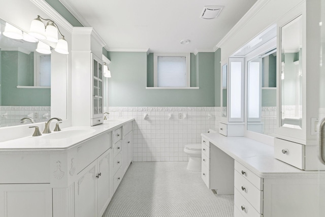 7604 Delaney Blvd, Edina, MN 55439 - bathroom with tile walls, a sink, toilet, double vanity, and tile patterned flooring