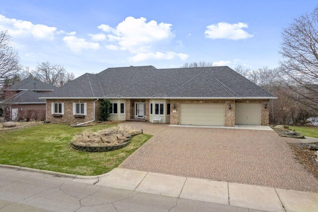 7604 Delaney Blvd, Edina, MN 55439 - ranch-style home featuring decorative driveway, a front yard, brick siding, and a garage