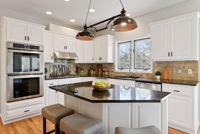 7604 Delaney Blvd, Edina, MN 55439 - kitchen featuring stainless steel appliances, under cabinet range hood, white cabinets, and recessed lighting