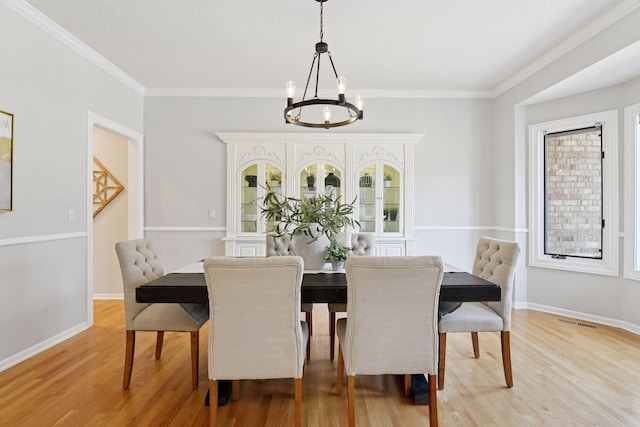 7604 Delaney Blvd, Edina, MN 55439 - dining space featuring a chandelier, light wood-style floors, and crown molding