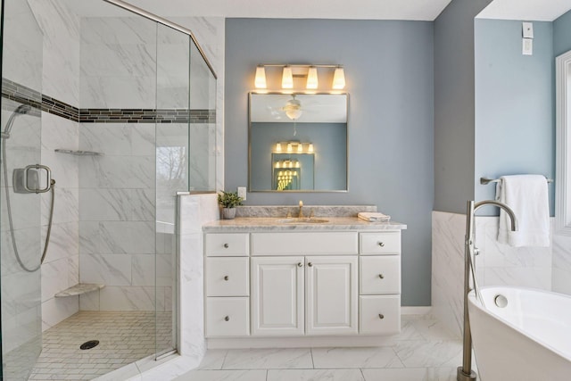 7604 Delaney Blvd, Edina, MN 55439 - full bathroom featuring marble finish floors, a soaking tub, a stall shower, and vanity
