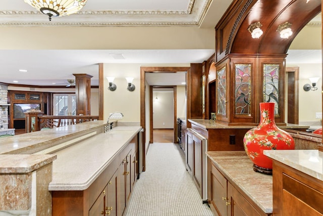 7604 Delaney Blvd, Edina, MN 55439 - kitchen with ceiling fan, arched walkways, brown cabinets, recessed lighting, and light stone counters