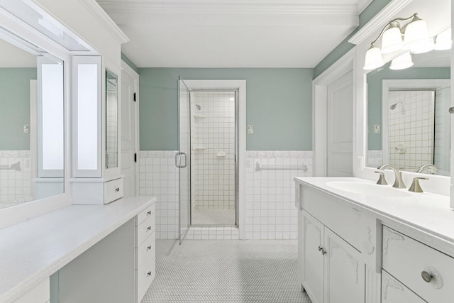 7604 Delaney Blvd, Edina, MN 55439 - bathroom featuring tile walls, vanity, a stall shower, a wainscoted wall, and ornamental molding