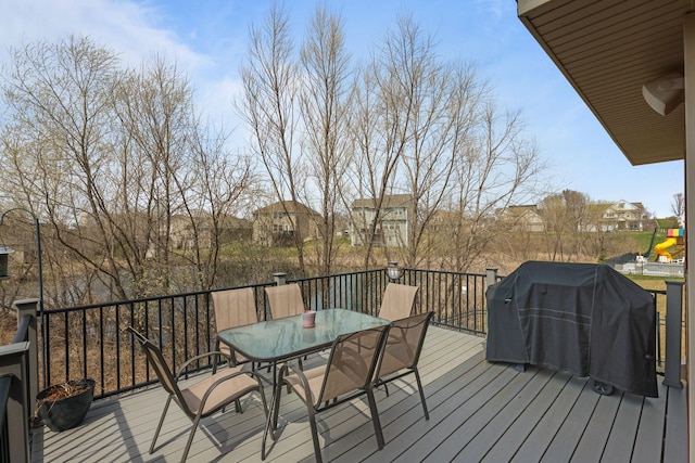 5836 Radford Ave NE, Otsego, MN 55374 - wooden terrace featuring grilling area, outdoor dining space, and a residential view