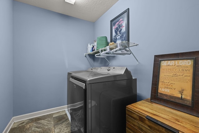 5836 Radford Ave NE, Otsego, MN 55374 - laundry room featuring a textured ceiling, baseboards, stone finish flooring, washer and dryer, and laundry area
