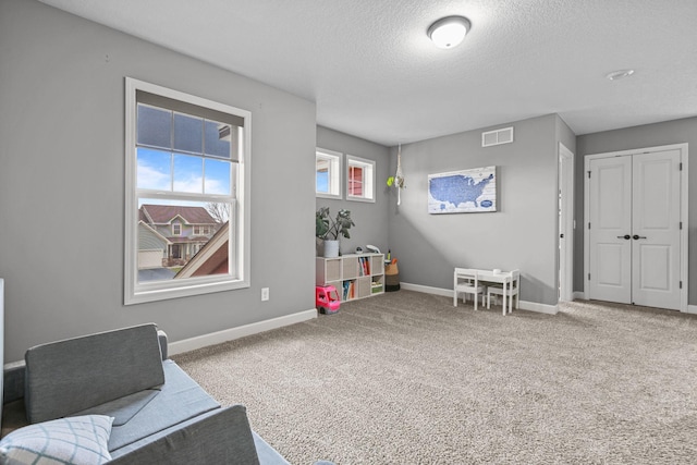 5836 Radford Ave NE, Otsego, MN 55374 - recreation room featuring baseboards, carpet floors, visible vents, and a textured ceiling