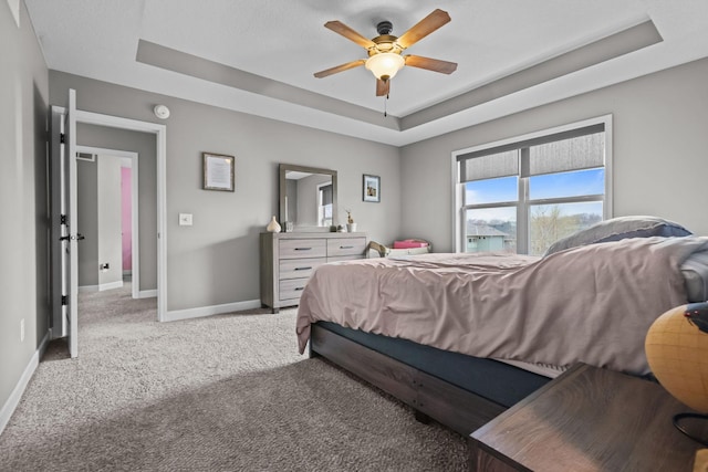 5836 Radford Ave NE, Otsego, MN 55374 - carpeted bedroom featuring a raised ceiling, baseboards, and ceiling fan
