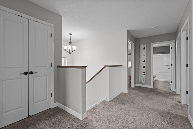 5836 Radford Ave NE, Otsego, MN 55374 - corridor with a textured ceiling, baseboards, carpet, and an upstairs landing