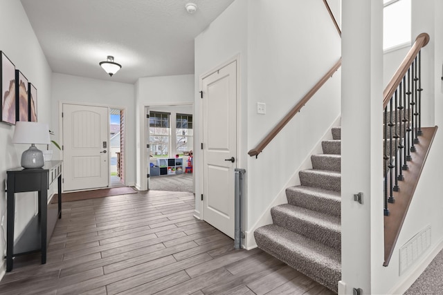 5836 Radford Ave NE, Otsego, MN 55374 - foyer with visible vents, wood finished floors, a textured ceiling, and stairway