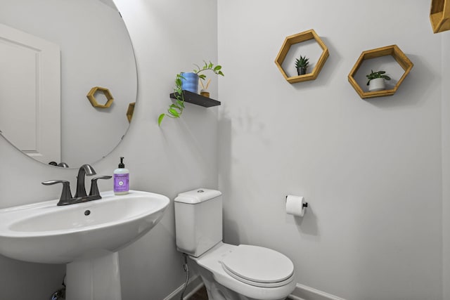 5836 Radford Ave NE, Otsego, MN 55374 - bathroom featuring baseboards, toilet, and a sink