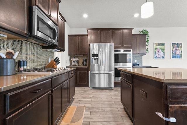 5836 Radford Ave NE, Otsego, MN 55374 - kitchen with dark brown cabinets, backsplash, appliances with stainless steel finishes, and light wood-type flooring