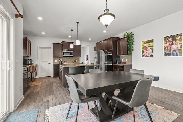5836 Radford Ave NE, Otsego, MN 55374 - dining area featuring baseboards, wood finished floors, and recessed lighting