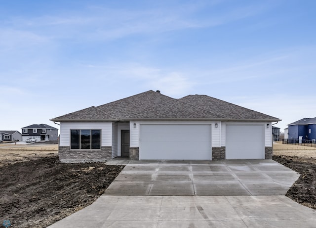 10218 73rd St S, Horace, ND 58047 - view of front of home with roof with shingles, driveway, and a garage