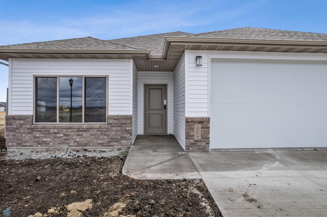 10218 73rd St S, Horace, ND 58047 - view of front facade with a shingled roof, brick siding, and a garage