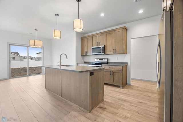 10218 73rd St S, Horace, ND 58047 - kitchen featuring dark countertops, light wood-type flooring, stainless steel appliances, and a sink