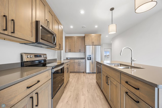 10218 73rd St S, Horace, ND 58047 - kitchen featuring a sink, hanging light fixtures, light wood-style flooring, appliances with stainless steel finishes, and recessed lighting