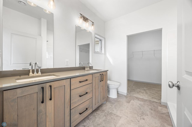 10218 73rd St S, Horace, ND 58047 - full bathroom with a walk in closet, toilet, a sink, and double vanity