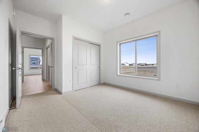 10218 73rd St S, Horace, ND 58047 - unfurnished bedroom with light colored carpet, baseboards, and a closet