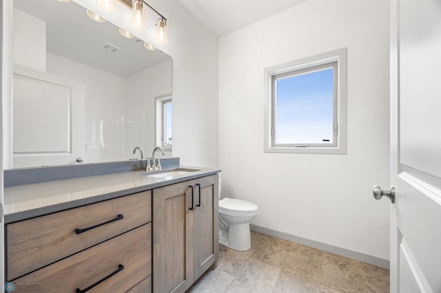 10218 73rd St S, Horace, ND 58047 - bathroom featuring toilet, vanity, visible vents, and baseboards