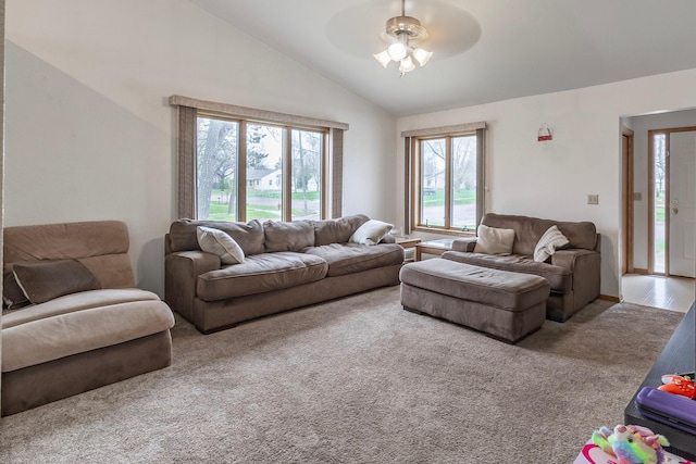 living room with a ceiling fan, lofted ceiling, and carpet