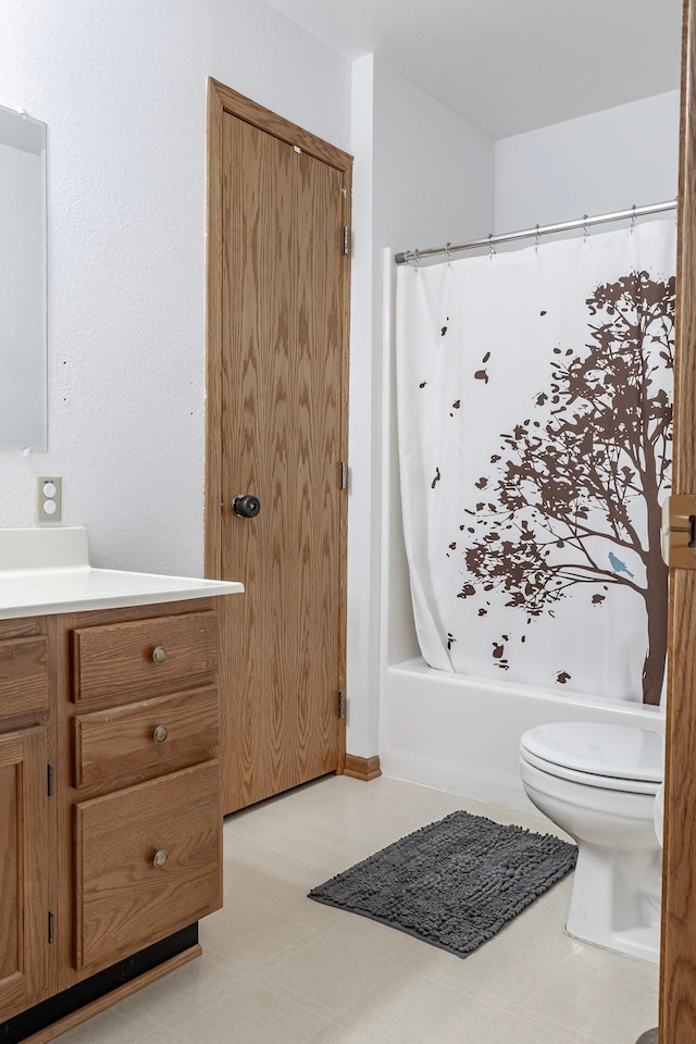 bathroom featuring toilet, vanity, shower / tub combo, and tile patterned floors