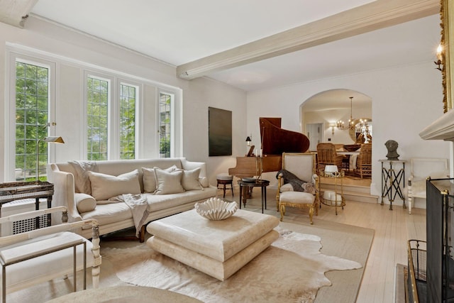 4232 Fremont Ave S, Minneapolis, MN 55409 - living area featuring arched walkways, a chandelier, beamed ceiling, and light wood-type flooring