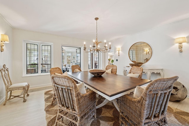 4232 Fremont Ave S, Minneapolis, MN 55409 - dining area with a chandelier and light wood-style flooring