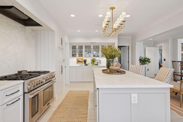 4232 Fremont Ave S, Minneapolis, MN 55409 - kitchen with double oven range, crown molding, a kitchen island, light countertops, and recessed lighting
