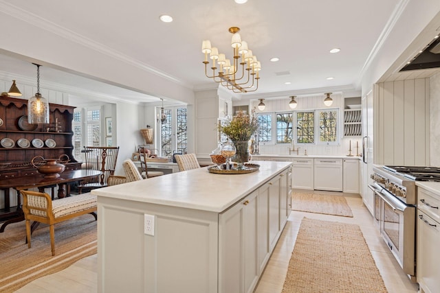 4232 Fremont Ave S, Minneapolis, MN 55409 - kitchen with double oven range, a kitchen island, healthy amount of natural light, pendant lighting, and crown molding
