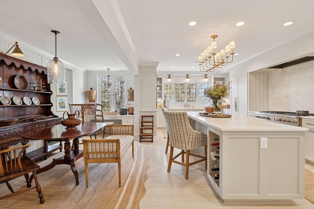 4232 Fremont Ave S, Minneapolis, MN 55409 - dining space with crown molding, a chandelier, light wood-style flooring, and recessed lighting