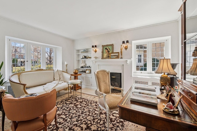 4232 Fremont Ave S, Minneapolis, MN 55409 - living area with built in shelves, a fireplace with flush hearth, and ornamental molding
