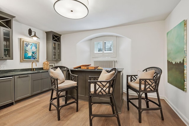 4232 Fremont Ave S, Minneapolis, MN 55409 - dining area featuring light wood-type flooring, radiator heating unit, and bar