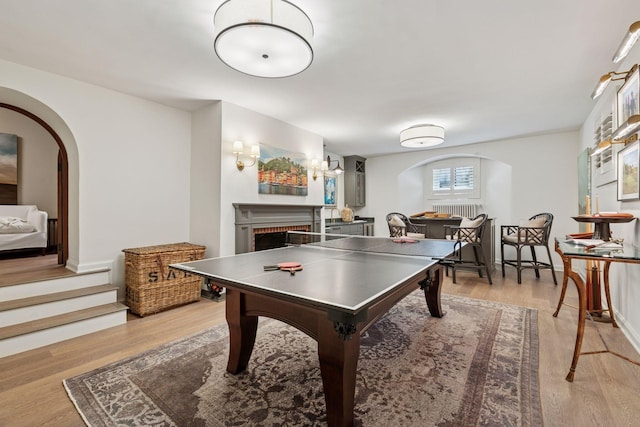 4232 Fremont Ave S, Minneapolis, MN 55409 - game room with arched walkways, a brick fireplace, and wood finished floors