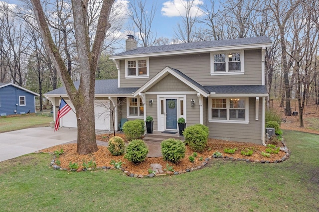 traditional home with a shingled roof, a front yard, a chimney, and concrete driveway