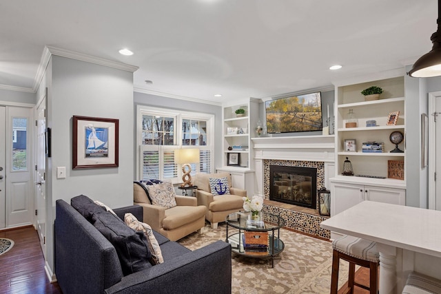 living room featuring a tiled fireplace, recessed lighting, ornamental molding, and dark wood finished floors