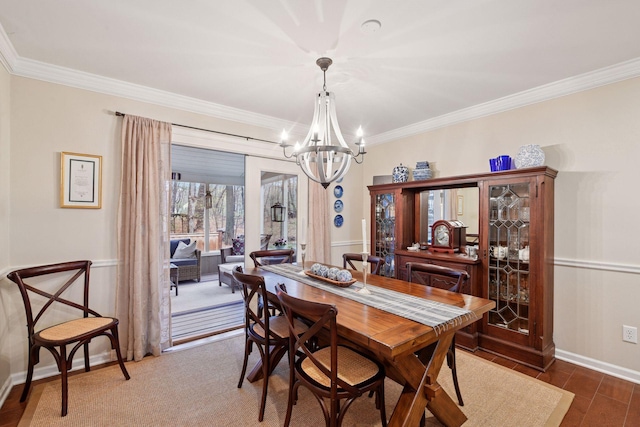 dining space featuring an inviting chandelier, baseboards, crown molding, and wood finished floors