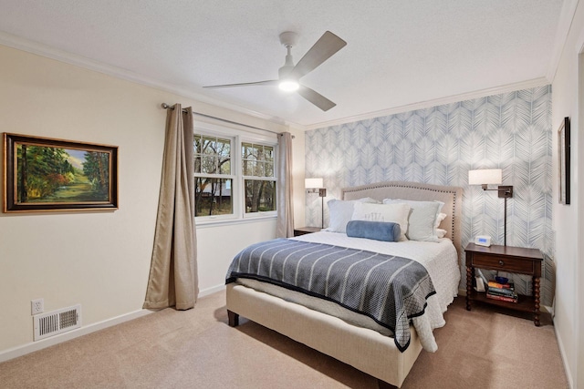 bedroom featuring carpet, baseboards, wallpapered walls, visible vents, and ornamental molding