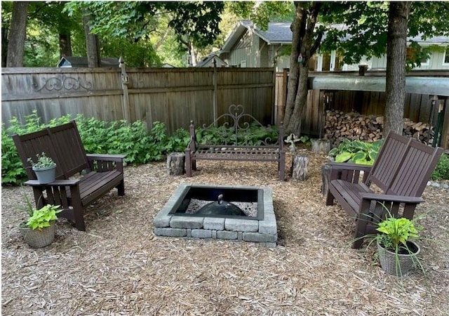 exterior space with fence and a fire pit
