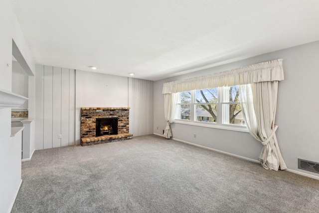 unfurnished living room featuring visible vents, carpet, and a fireplace