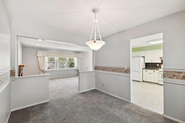 interior space featuring baseboards and light carpet
