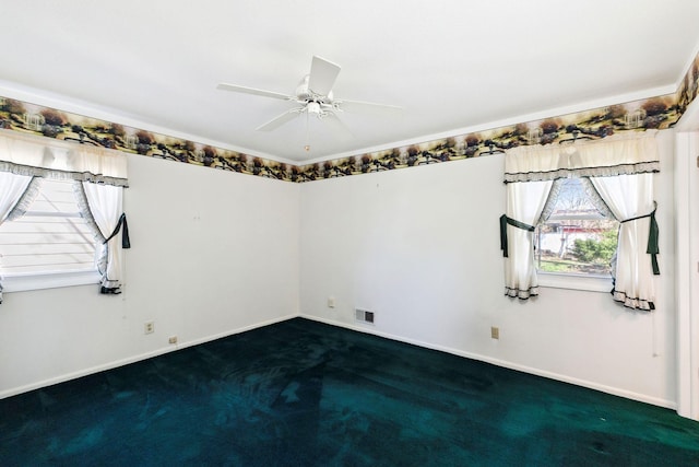 empty room featuring a ceiling fan, baseboards, visible vents, and dark colored carpet