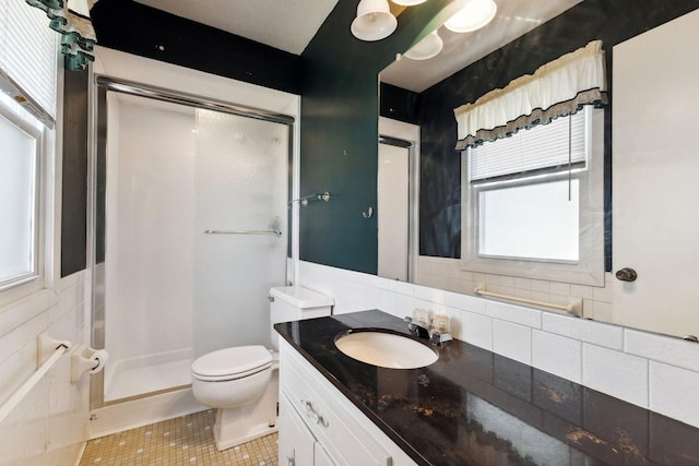 full bath featuring vanity, toilet, tile patterned flooring, and a stall shower