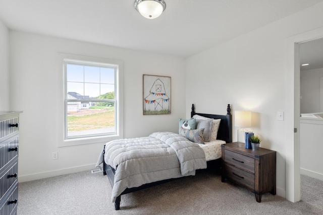carpeted bedroom with baseboards