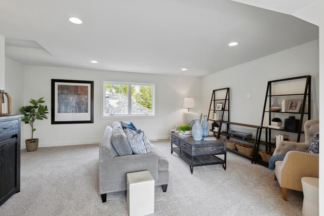 living area with baseboards, recessed lighting, and light colored carpet