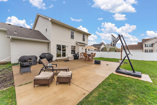 rear view of house with a lawn, outdoor dining area, a patio area, and fence